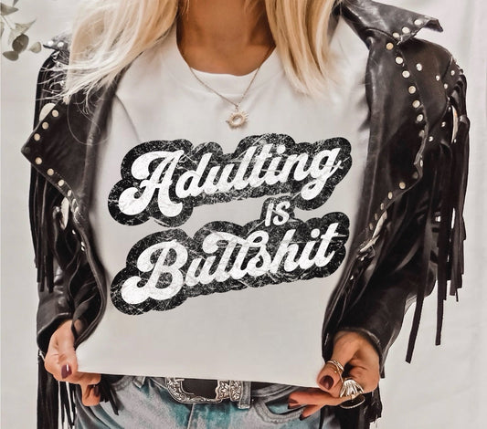 Adulting Is Bullshit Graphic on Gildan Softstyle White Shirt – Graphic Tee, Long Sleeve & Crewneck.