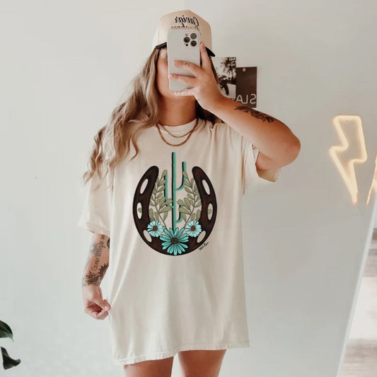 Turquoise Horseshoe Cactus Floral Graphic on Gildan Softstyle Natural Shirt – Graphic Tee, Long Sleeve & Crewneck.